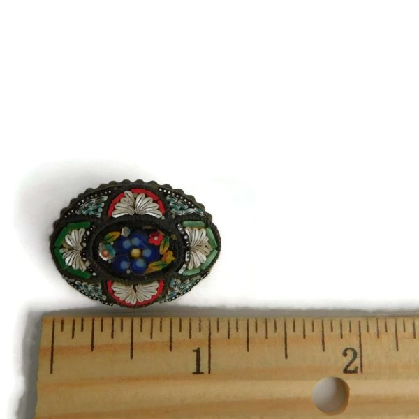 mosaic brooch with ruler for scale