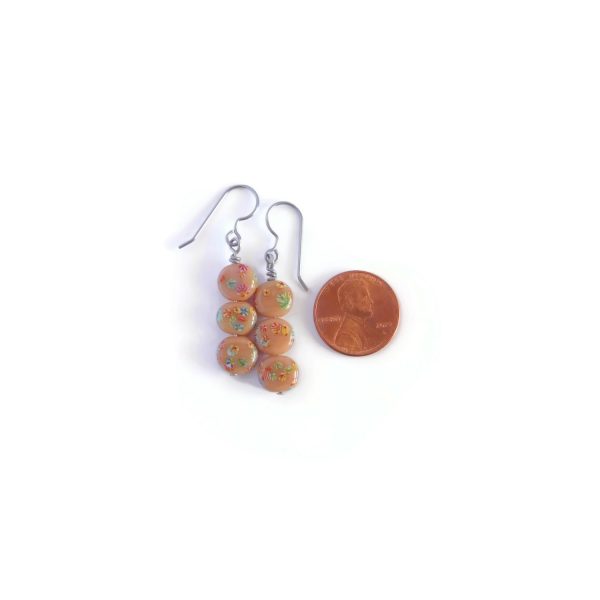brown millefiori earrings with penny for scale