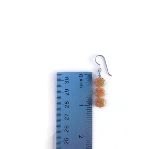 brown millefiori earrings with ruler for scale