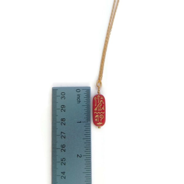 cartouche necklace with ruler for scale