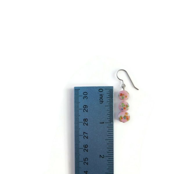 pink millefiori earrings with ruler for scale