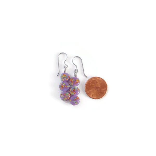 purple tombo bead earrings with penny for scale