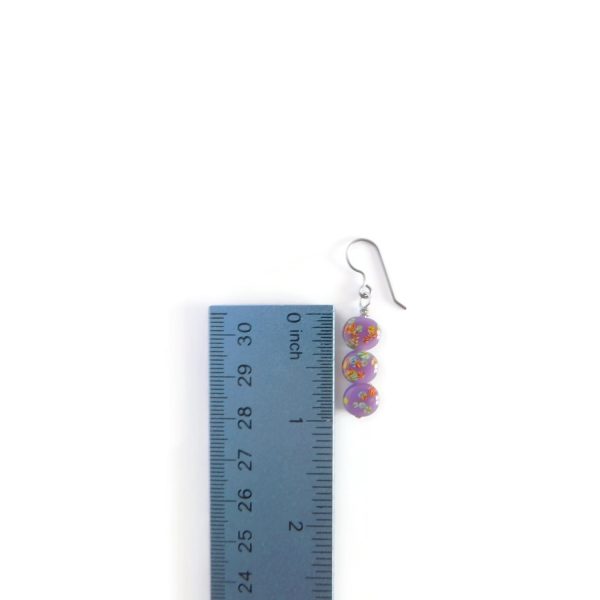 purple tombo bead earrings with ruler for scale