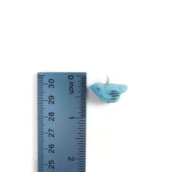 bird charm with ruler for scale