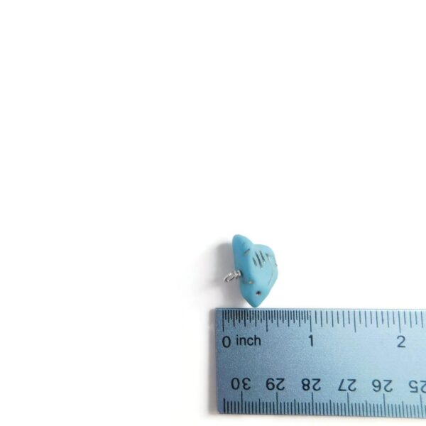 bird charm with ruler for scale