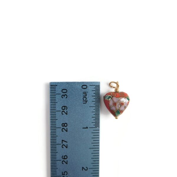 cloisonne heart pendant with ruler for scale