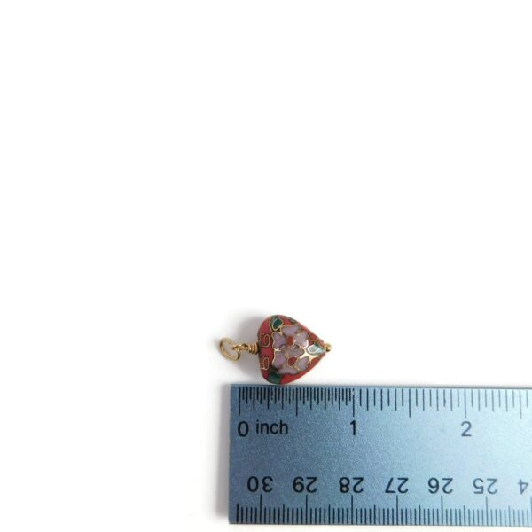 cloisonne heart pendant with ruler for scale