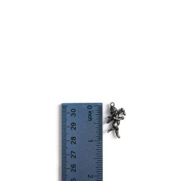 cupid charm with ruler for scale