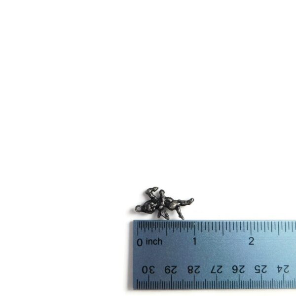 cupid charm with ruler for scale