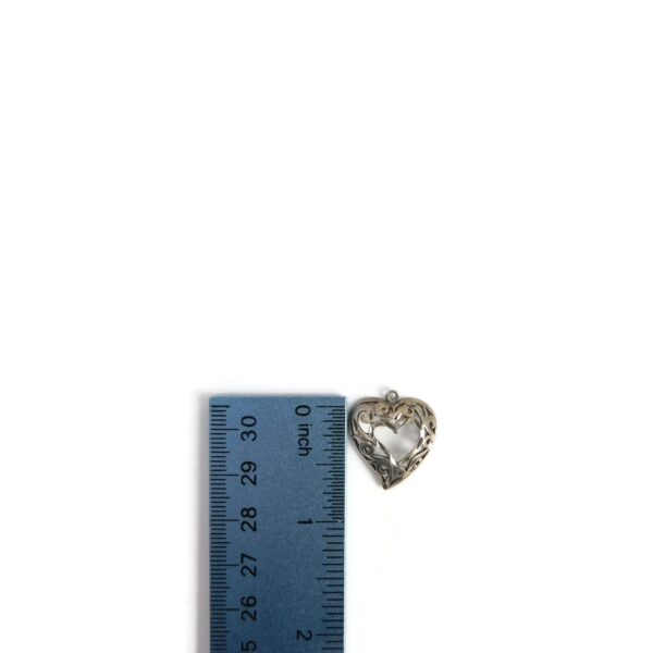 filigree heart pendant with ruler for scale