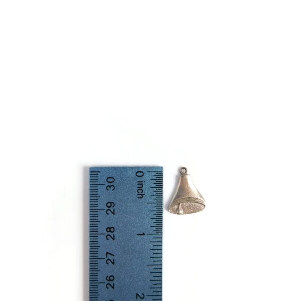 flat bell charm with ruler for scale