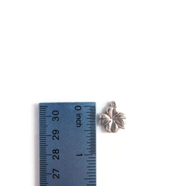 four leaf clover charm with ruler for scale