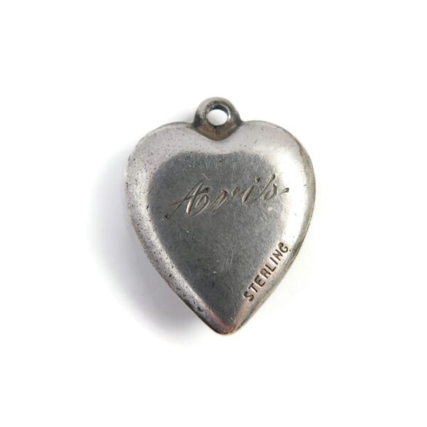 back of heart charm with boat