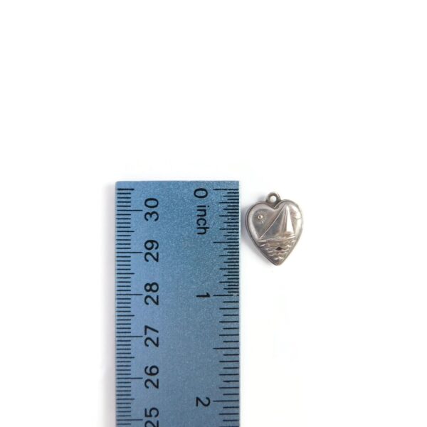 heart charm with boat with ruler for scale