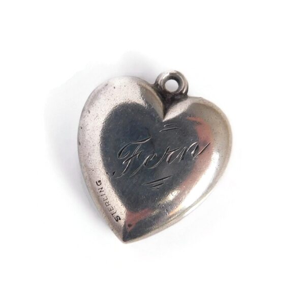 back of heart charm with hands
