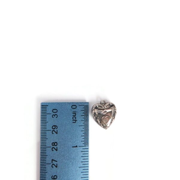 heart charm with hands with ruler for scale