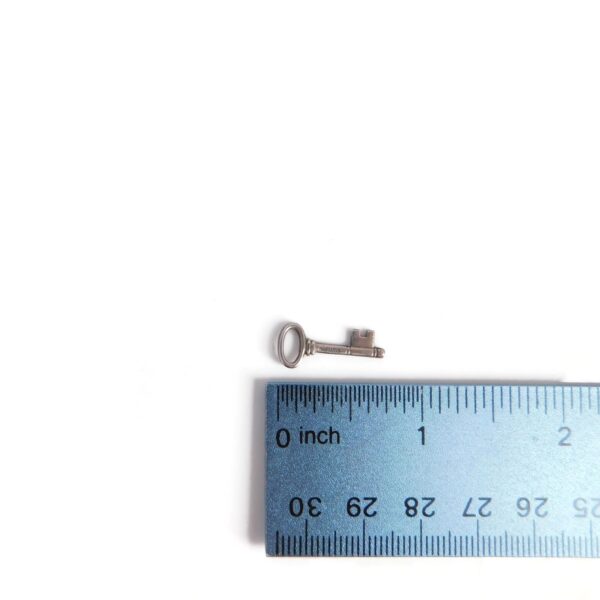 key charm with ruler for scale