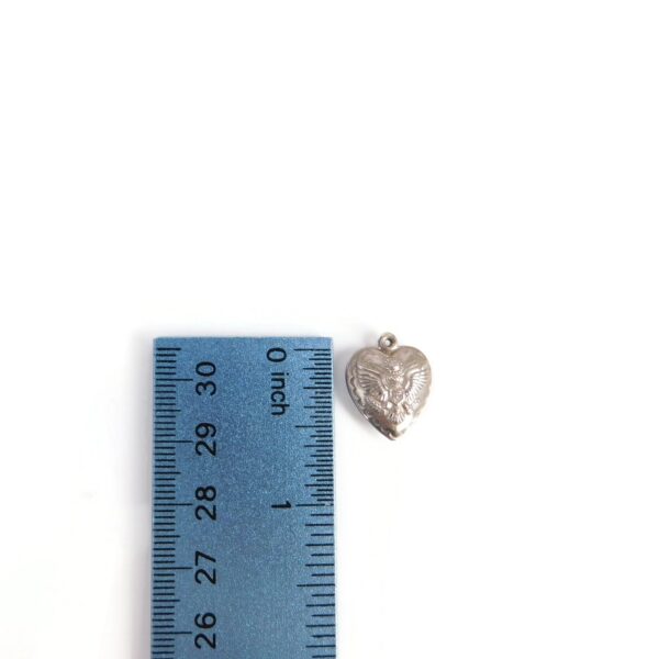 military heart charm with ruler for scale