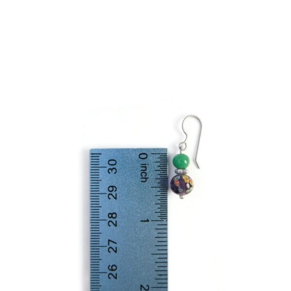 purple and green earrings with ruler for scale