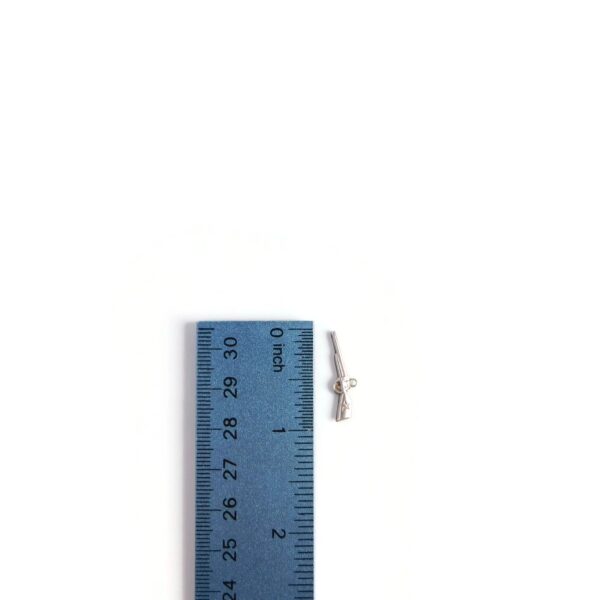 rifle charm with ruler for scale