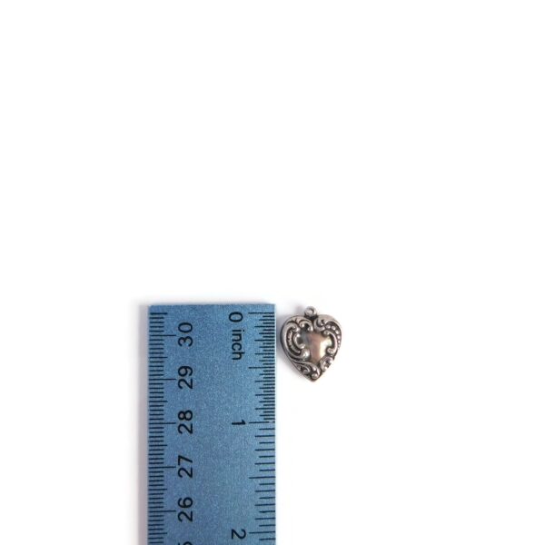silver heart charm with ruler for scale
