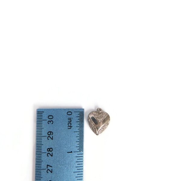 victory heart charm with ruler for scale