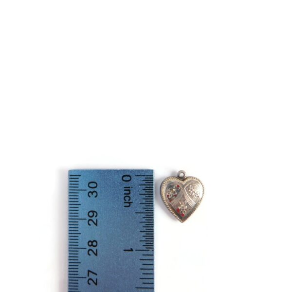 vintage heart charm with ruler for scale