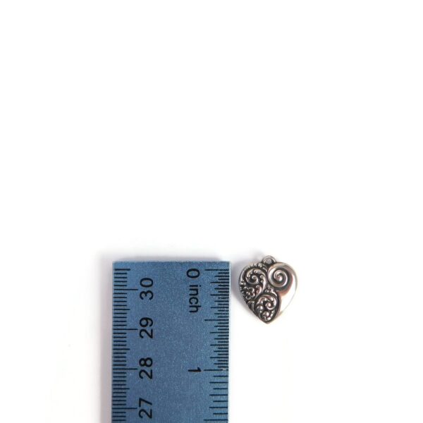 vintage heart charm with ruler for scale