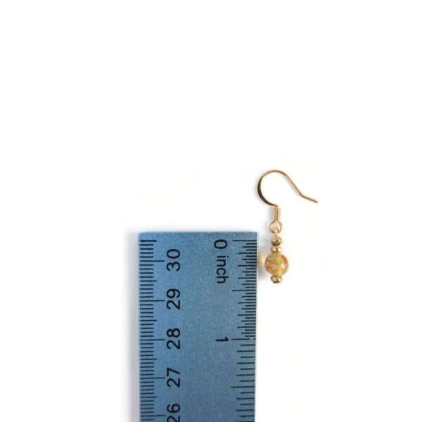 yellow earrings with ruler for scale