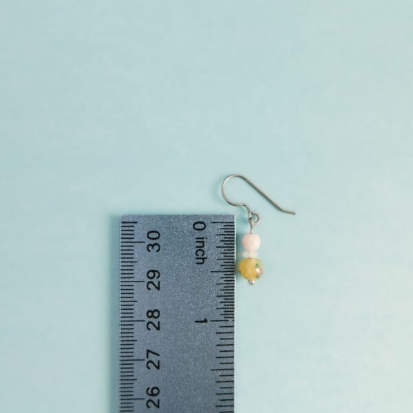 yellow lampwork earrings with ruler for scale